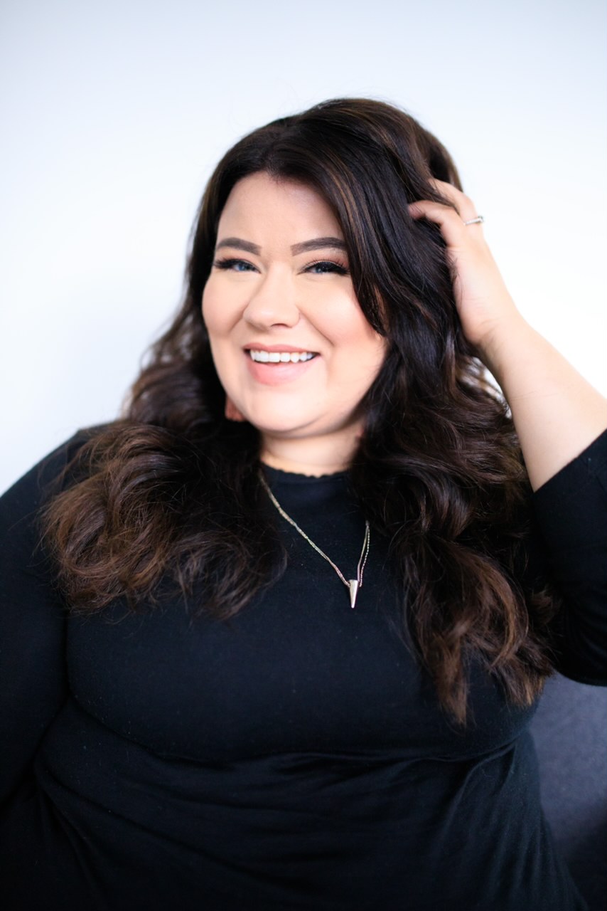 Carly Stark Nader smiling, with her long brunette hair